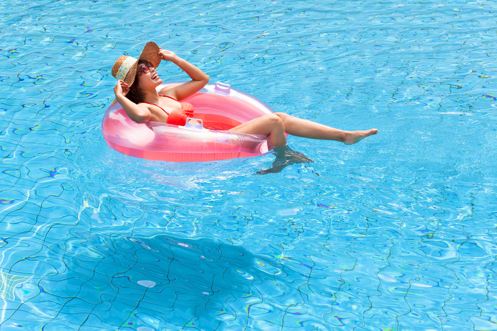 lady floating in her inner tube in swimming pool