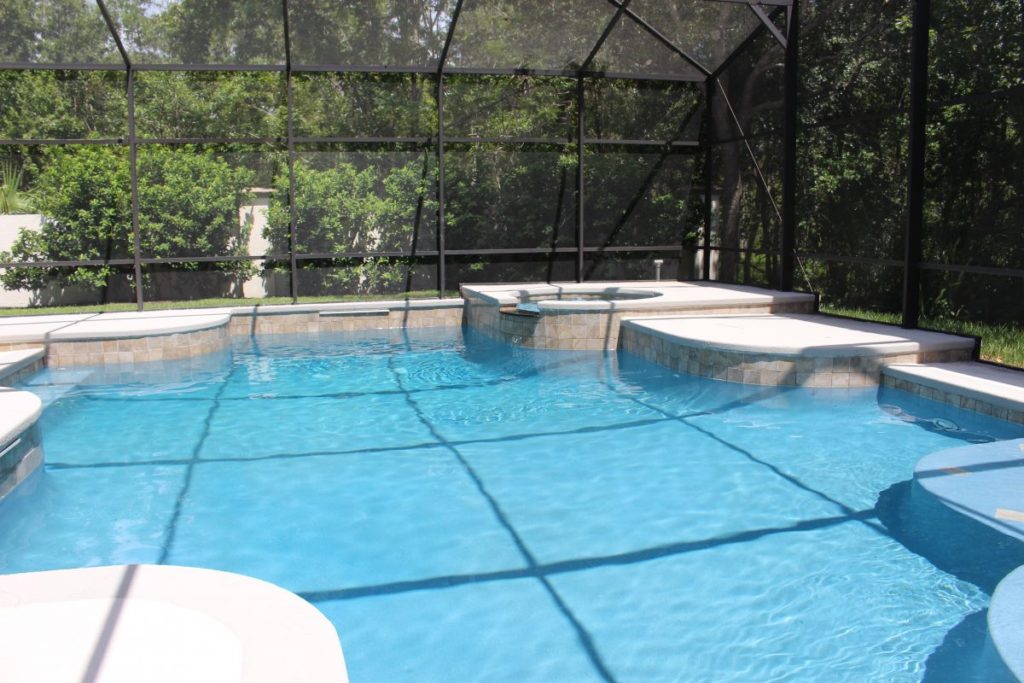 clean pool with pool cage over it