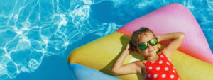 Child relaxing on a float in a pool, enjoying the effortless pool care provided by smart pool automation.