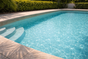 spring pool service Orlando shown by a bright teal backyard pool in afternoon light with gentle ripples and a soft palm shadow on the deck.