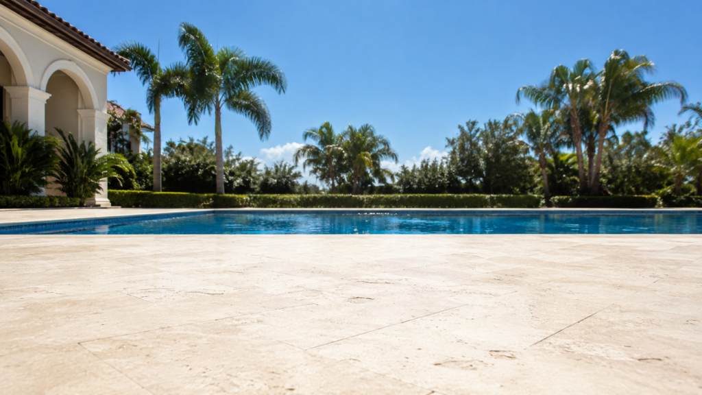 Summer pool care Orlando shown by a bright residential pool with visible heat shimmer rising above the sunlit stone deck.
